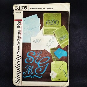 May include: Vintage Simplicity embroidery transfer pattern, featuring examples of monogrammed towels, handkerchiefs, and a shirt. The design includes the numbers "5175" and the text "EMBROIDERY TRANSFER". The color palette includes shades of blue, green, and white.
