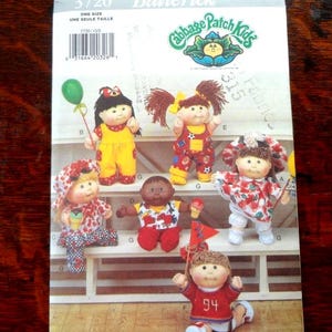 May include: A vintage Butterick sewing pattern featuring Cabbage Patch Kids dolls. The pattern includes images of several dolls in various outfits, with the "Cabbage Patch Kids" logo visible. The pattern number is 3720.