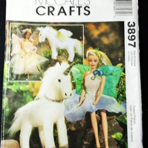 May include: McCall's Crafts pattern featuring a fairy doll and a white unicorn. The pattern includes images of the finished crafts. The cover has the number 3897 and the text "One Envelope, Une Pochette, Un Sobre."