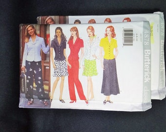 May include: Two Butterick sewing pattern envelopes. The patterns feature illustrations of women's suits and separates, including blazers, skirts, and pants. The envelopes display the Butterick Classics logo and size information.