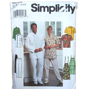 May include: Simplicity sewing pattern for chef uniforms. The package shows a man and woman in chef attire, along with illustrations of various uniform styles, including jackets, shirts, pants, and aprons. The package is white with the Simplicity logo.