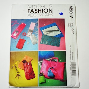 May include: A vintage McCall's Fashion Accessories sewing pattern. The cover features colorful illustrations of various accessories, including purses, phone cases, and keychains. The pattern number is M5012.
