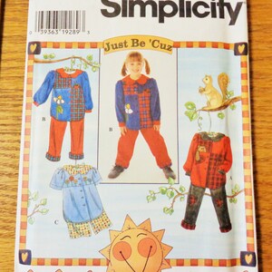 May include: Simplicity sewing pattern 7277 for children's clothing. The pattern features designs for pajamas and outfits with floral and plaid accents. The text "Just Be 'Cuz" is displayed above a child's image. Size AA 3,4,5,6.