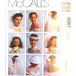 May include: A vintage McCall's sewing pattern envelope featuring nine bridal gown and veil designs. The cover displays images of brides in various styles, with the pattern number 2057 visible. The "Alicyn Exclusives" logo is at the bottom.