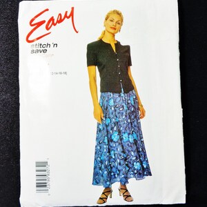 May include: A sewing pattern package with the word "Easy" in red script. The package features a woman wearing a black short-sleeved cardigan and a blue floral skirt. The text "stitch 'n save" is also visible.