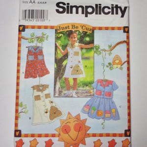 May include: Simplicity sewing pattern featuring children's dresses. The pattern includes designs with bee, ice cream, and sun graphics. The text "Just Be 'Cuz" is displayed above a photo of a child wearing a dress. Size AA 3,4,5,6.