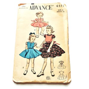 May include: Vintage sewing pattern for a girl's dress, featuring illustrations of three different dress designs. The pattern is labeled "ADVANCE" and includes size and breast measurements. The dresses are in blue, pink, and black floral patterns.