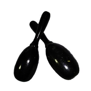 May include: Two black maracas with a glossy finish are crossed against a white background. The maracas have a teardrop-shaped body and a long, slender handle. Musical instruments.