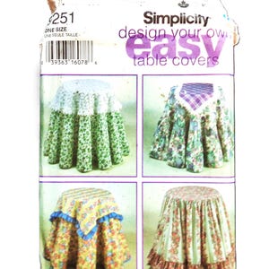 May include: Simplicity pattern 9251 for easy table covers. The package shows four different table cover designs with floral and patterned fabrics. The text "design your own easy table covers" is visible.