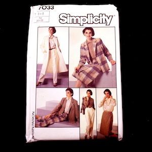 May include: A vintage Simplicity sewing pattern envelope featuring images of women's suits and separates. The envelope has the number 7033 and the Simplicity logo. The outfits include a long coat, skirt suit, and pantsuits in various colors and patterns.