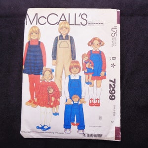 May include: McCall's sewing pattern for children's clothing. The pattern features illustrations of children wearing various outfits, including overalls and dresses. The pattern number is 7299.