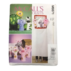 May include: McCall's Crafts sewing pattern featuring various animal hand puppets, including a lion, elephant, zebra, pig, and wolf. The pattern includes instructions for creating the puppets. The pattern is labeled M6671 and is size OSZ.