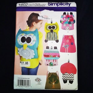 May include: Simplicity sewing pattern 1602 featuring various drawstring backpacks and an owl-shaped backpack. The pattern includes multiple designs with colorful fabrics and whimsical details. The price tag shows $17.95.