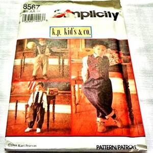 May include: Simplicity sewing pattern featuring children's clothing designs. The pattern cover includes images of children in various outfits, with the text "k.p. kid's & co." and the Simplicity logo. The pattern is dated 1994.