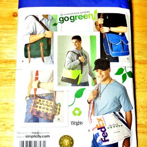 May include: A Simplicity 2358 sewing pattern envelope for messenger bags. The cover displays five variations of bags, including a green bag with brown straps, a blue bag with pockets, a plaid bag, a neon yellow bag, and a white FedEx branded bag.