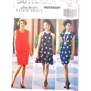 May include: Butterick sewing pattern 6099 featuring three dress designs. The pattern includes a red sheath dress, a navy blue halter dress with white and red polka dots, and a navy blue dress with white and red polka dots. The text "FAST & EASY" is visible.