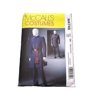 May include: A McCall's Costumes pattern envelope. The front features a navy blue military-style costume with gold buttons, a red sash, and matching pants. The text "McCall's Costumes" is at the top.