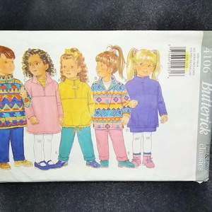 May include: A Butterick sewing pattern for children's clothing, featuring illustrations of various outfits. The pattern includes a pullover, pants, and a tunic dress. The cover displays the number 4106 and the words "Fast & Easy Classics."