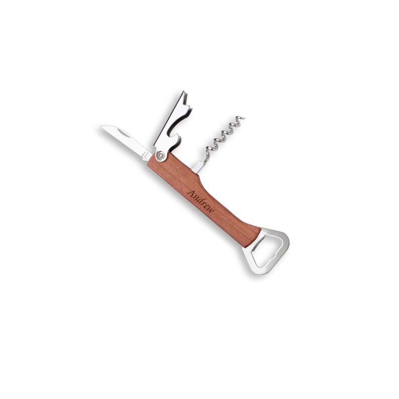 May include: A multi-tool wine opener with a wooden handle and stainless steel components. Features a corkscrew, bottle opener, and knife. The name "Andrew" is engraved on the handle.