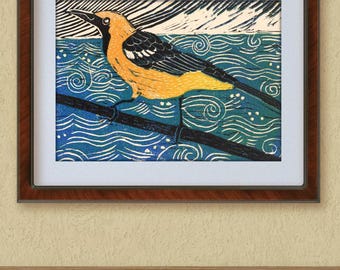 May include: A woodblock print of a yellow and black bird perched on a branch over a blue and white patterned water scene.