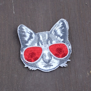 May include: A set of three ceramic mugs with a speckled, matte finish. The mugs are in shades of cream, light gray, and dark gray. Each mug has a simple, minimalist design, perfect for coffee or tea.