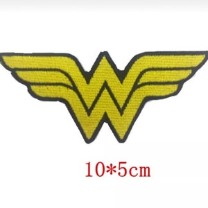 May include: Yellow Wonder Woman logo iron-on patch with black outline. The patch is 10 by 5 centimeters.