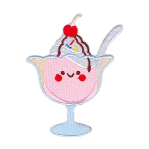 May include: An embroidered ice cream sundae patch with a cherry on top and a blue glass. The ice cream has a smiling face with red cheeks.