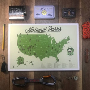 May include: A green and white map of the United States with the text "National Parks" at the top. The map shows the location of all the national parks in the United States. The map is surrounded by various camping and outdoor gear, including a compass, a rope, a pencil, a small first aid kit, and a flask.