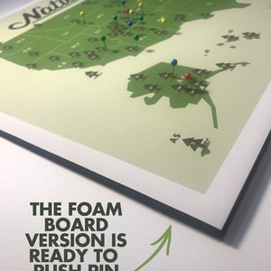 May include: A green map of the United States with push pins marking locations. The map is titled "National Parks" and includes the text "The foam board version is ready to push pin. Also includes 100 sorted pins."