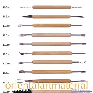 May include: Set of 10 sculpting tools with wooden handles and various metal tips. The tools range in size from 13.0 cm to 20.0 cm.  The tools are arranged vertically with the longest tool at the bottom and the shortest tool at the top.  The tools are all made of metal and wood.  The tools are all different shapes and sizes.  The tools are all used for sculpting.