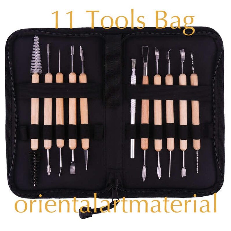 May include: A black zippered pouch containing 11 tools for sculpting and crafting. The tools are arranged in two rows and have wooden handles. The pouch has the text "11 Tools Bag" printed on the front and "orientalartmaterial" printed on the bottom.