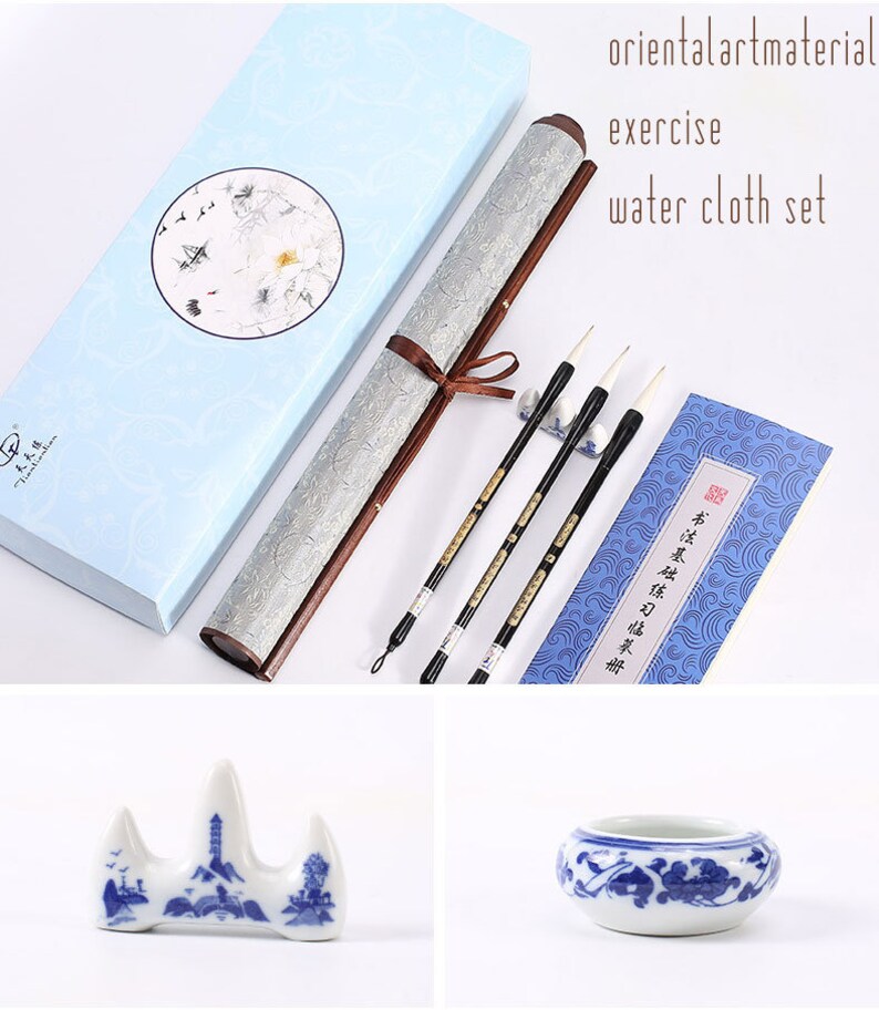 May include: A set of Chinese calligraphy supplies, including a scroll, three brushes, a brush holder, a blue and white porcelain inkwell, and a blue and white porcelain brush rest. The scroll is in a blue box with a white floral design. The brushes are in a clear plastic holder. The inkwell and brush rest are both decorated with a traditional Chinese design.