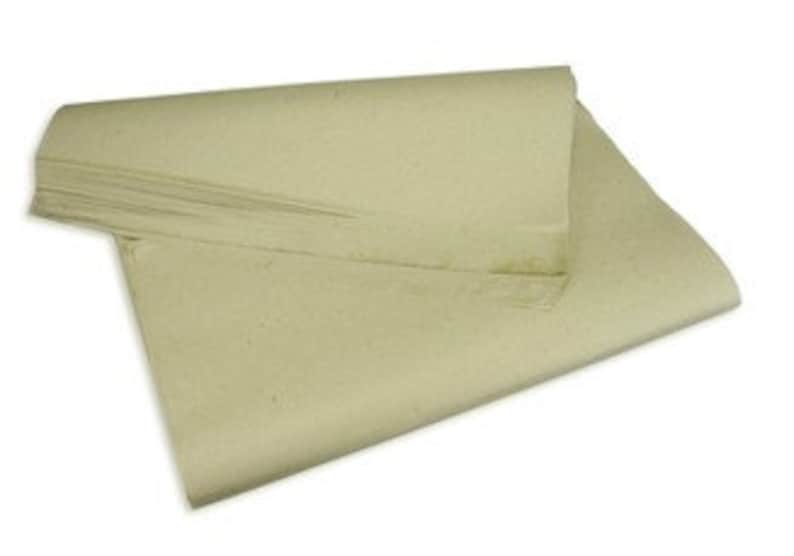 May include: A stack of unbleached, natural brown paper sheets. The paper is smooth and has a slightly textured surface.