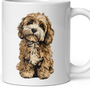 May include: White ceramic mug featuring a detailed illustration of a fluffy, brown and cream-colored puppy. The puppy is sitting upright, with its head tilted slightly. The mug has a curved handle and a glossy finish.