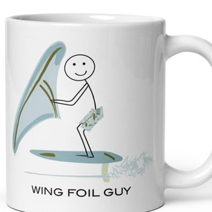 May include: White ceramic mug with a stick figure illustration of a person wing foiling. The text "WING FOIL GUY" is printed on the mug.