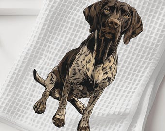 May include: A white waffle-weave kitchen towel featuring a detailed illustration of a brown and white German Shorthaired Pointer dog. The dog is depicted in a seated position, showcasing its spotted coat, dark ears, and alert facial expression.