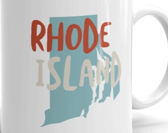 May include: White ceramic mug with a blue and white outline of the state of Rhode Island and the text "RHODE ISLAND" in red and white lettering.