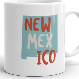 May include: White ceramic mug with a blue outline of the state of New Mexico and the text "NEW MEX ICO" in red and white.