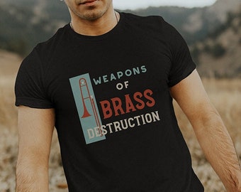 May include: A black t-shirt with a graphic of a trombone and the text "Weapons of Brass Destruction".