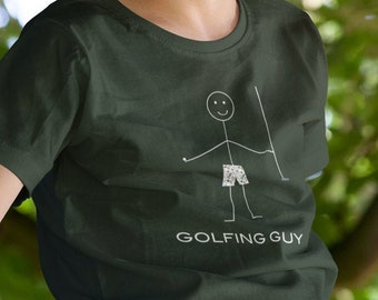 May include: A young person wearing a dark green t-shirt with a white stick figure illustration of a golfer and the text "Golfing Guy". The person is sitting on a tree branch.
