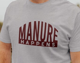 May include: A gray t-shirt with a maroon graphic that says "MANURE HAPPENS".
