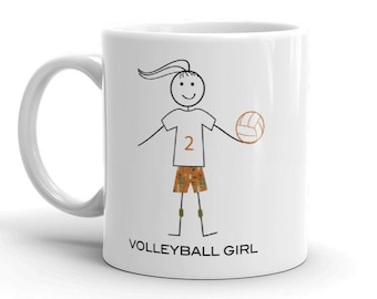 May include: White ceramic mug with a black stick figure illustration of a volleyball player holding a volleyball. The player is wearing a white shirt with the number 2 on it and orange and green shorts. The text "VOLLEYBALL GIRL" is printed on the bottom of the mug.