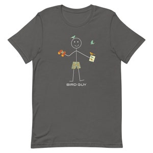 May include: Dark gray t-shirt featuring a stick figure with binoculars, bird watching guide, and patterned shorts. The stick figure is smiling with birds flying around. The text "BIRD GUY" is printed below the figure.
