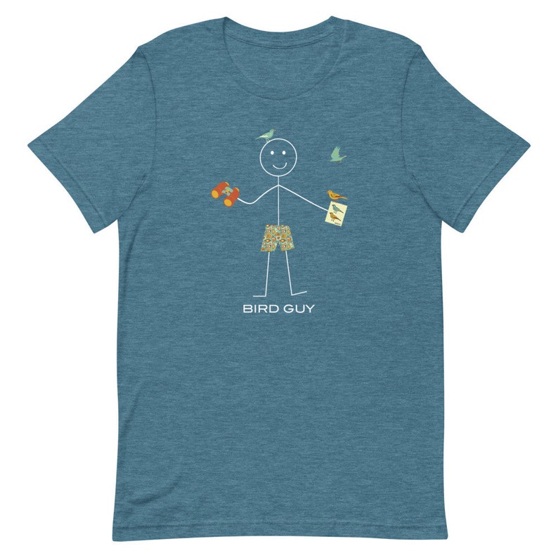 May include: A blue t-shirt with a stick figure design. The stick figure holds binoculars, a bird identification card, and is wearing patterned shorts. The text "BIRD GUY" is printed below the figure.