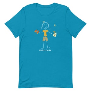 May include: A turquoise blue t-shirt with a stick figure illustration of a person holding binoculars and a bird watching guide. The text "BIRD GIRL" is printed below the illustration.