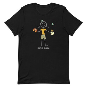 May include: Black t-shirt with a stick figure illustration of a person holding binoculars and a bird guide. The text "BIRD GIRL" is below the figure.