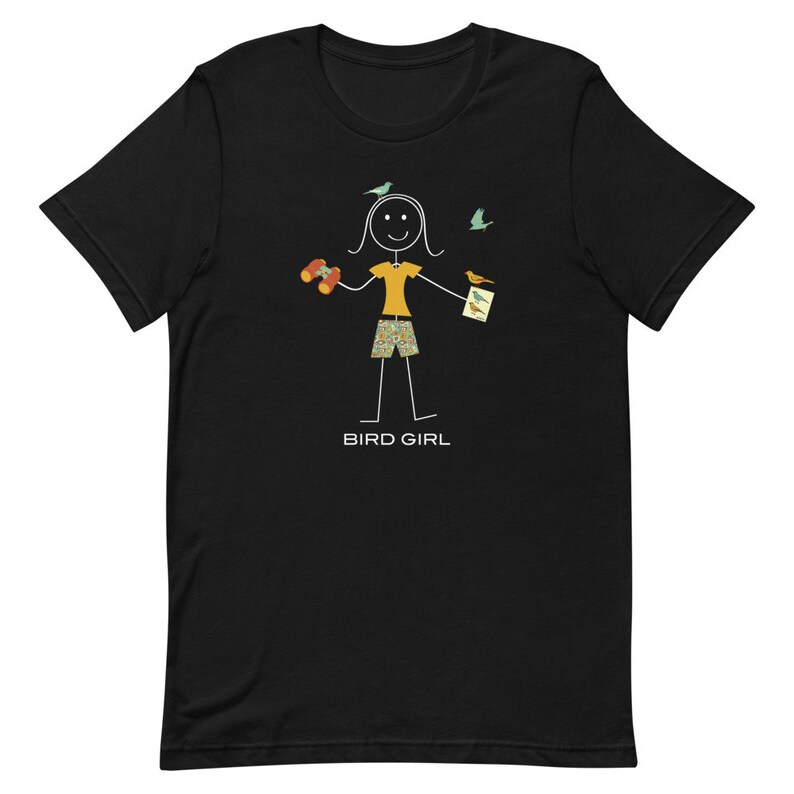 May include: Black t-shirt with a stick figure illustration of a person holding binoculars and a bird guide. The text "BIRD GIRL" is below the figure.