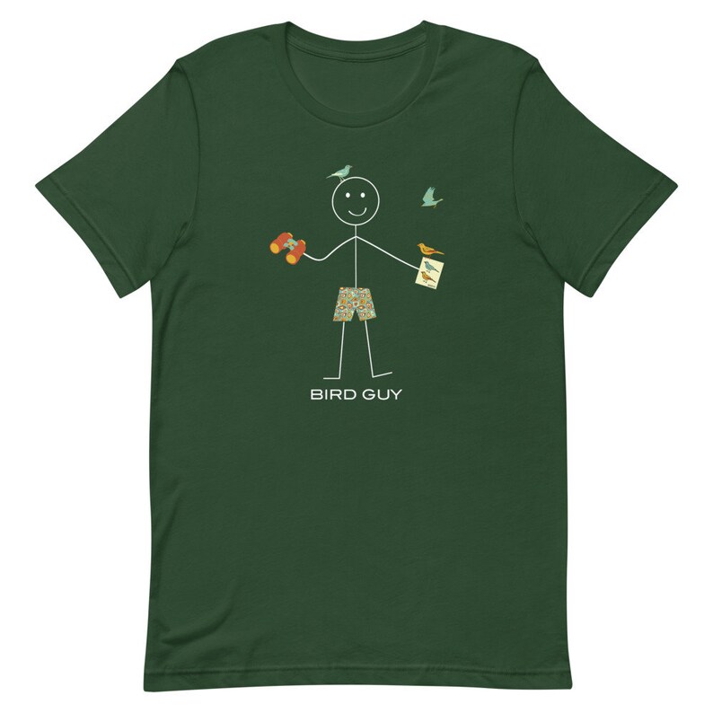 May include: Dark green t-shirt featuring a stick figure with binoculars and a bird guide, with birds flying around. The stick figure is wearing patterned shorts. The text "BIRD GUY" is printed below the figure.