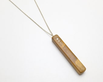 Yellow Persimmon wood pendant with silver inlaid details