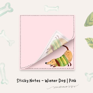 May include: Pink sticky notes with a watercolor illustration of a dachshund wearing a green and yellow striped sweater. The image includes scattered bone and leaf illustrations, and the text "Sticky Notes - Wiener Dog | Pink".